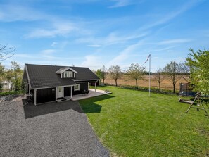 A modern house with a covered porch, a fenced yard, and a flagpole. - "Adelia" - 850m to the fjord by Interhome (Tarm)
