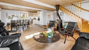 A modern living room with a dining area, wooden ceiling, and a staircase. - "Adelia" - 850m to the fjord by Interhome (Tarm)