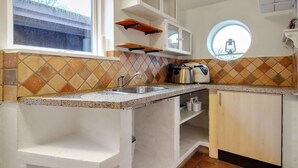 A kitchen with a sink, countertop, and a window. - "Claudia" by Interhome (Bredebro)