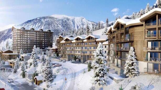 Ein Winterurort mit mehreren Gebäuden, darunter ein großes Hotel mit Balkonen und eine kleinere Lodge.