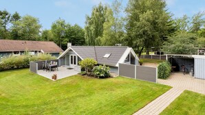 A residential property with a fenced backyard, a patio area with outdoor seating, and a garage. - "Liljana" - 30km from the sea by Interhome (Toftlund)