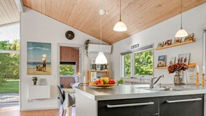 A modern kitchen with a large island, wooden ceiling, and pendant lights. - "Barne" - 4km from the sea by Interhome (Sæby)