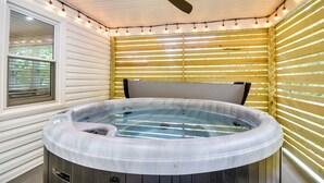 Ein Whirlpool in einem Zimmer mit Holzwänden und Deckenventilator.