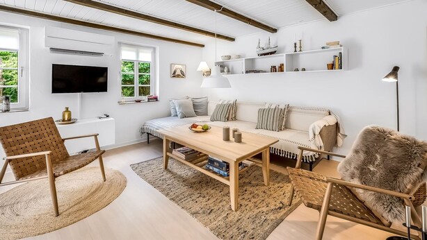 A modern living room with a wooden ceiling, white walls, a sofa, a coffee table, and a TV. - "Alkil" - 1.7km from the sea by Interhome (Ulfborg)