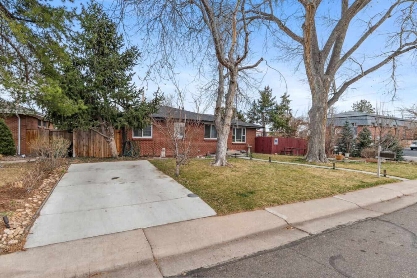 A residential area with a house, a driveway, and a sidewalk.