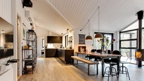 A spacious kitchen with a central island, wooden flooring, and a large window providing natural light. - "Eliz" - 800m from the sea by Interhome (Nexø)