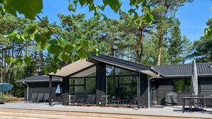 A modern building with a covered patio area, outdoor seating, and a barbecue setup. - "Eliz" - 800m from the sea by Interhome (Nexø)