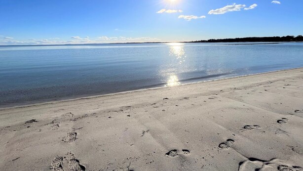 A beach with footprints in the sand and a clear sky. - "Rikkie" - 150m to the fjord by Interhome (Rørvig)