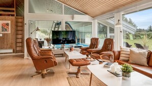 A spacious living area with leather sofas, a coffee table, and a TV. - "Helene" - 1.5km from the sea by Interhome (Blokhus)