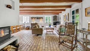 A cozy living room with a fireplace, wooden beams, a television, and a comfortable seating area. - "Tatiane" - 10km from the sea by Interhome (Bækmarksbro)