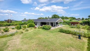 A modern house with a covered patio, surrounded by well-maintained lawns and gardens. - "Asko" - 350m from the sea by Interhome (Ebeltoft)