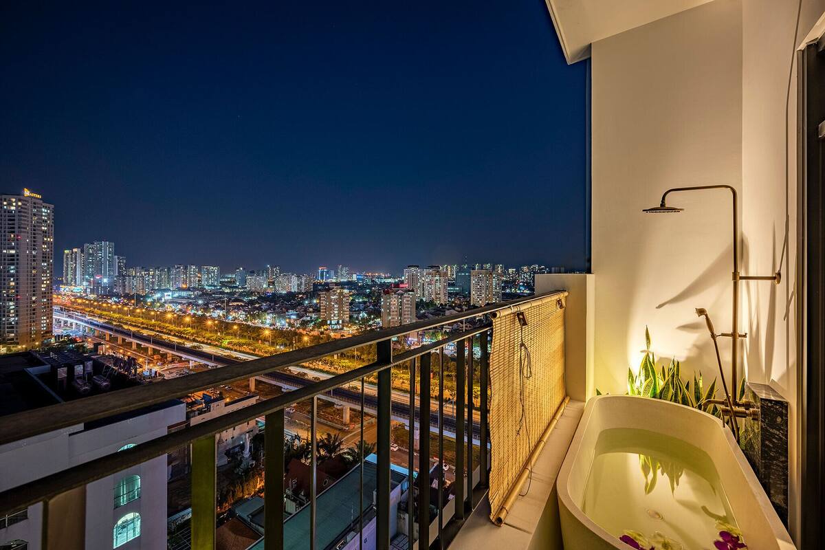 A balcony with a city view, a bathtub, and a shower.