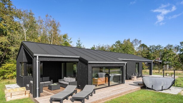 A modern house with a deck, outdoor seating, and a barbecue area. - "Sinna" -  from the sea by Interhome (Hals)