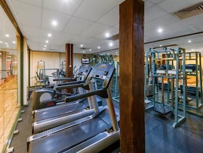 Stay fit and active with our well-equipped gym featuring treadmills, weightlifting equipment, and a modern design.