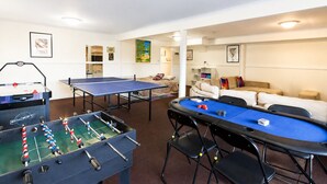 A room with a foosball table, a ping pong table, and a pool table. - Carlenes Getaway | Lake Views, Beach & Games Hub (Loch Sport)