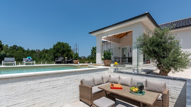 An outdoor patio with a pool, wicker furniture, and a dining area. - Sienna Zminj in Krculi (Zminj)
