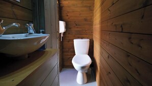 A wooden cabin bathroom with a sink and toilet. - Ocean View 1 - 1 Bed Pod - Llanrhidian (Swansea)