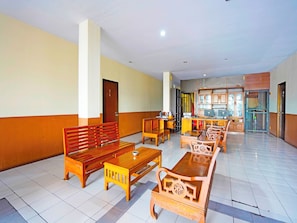 Relax in the spacious lobby with a central seating area and kitchen nearby.