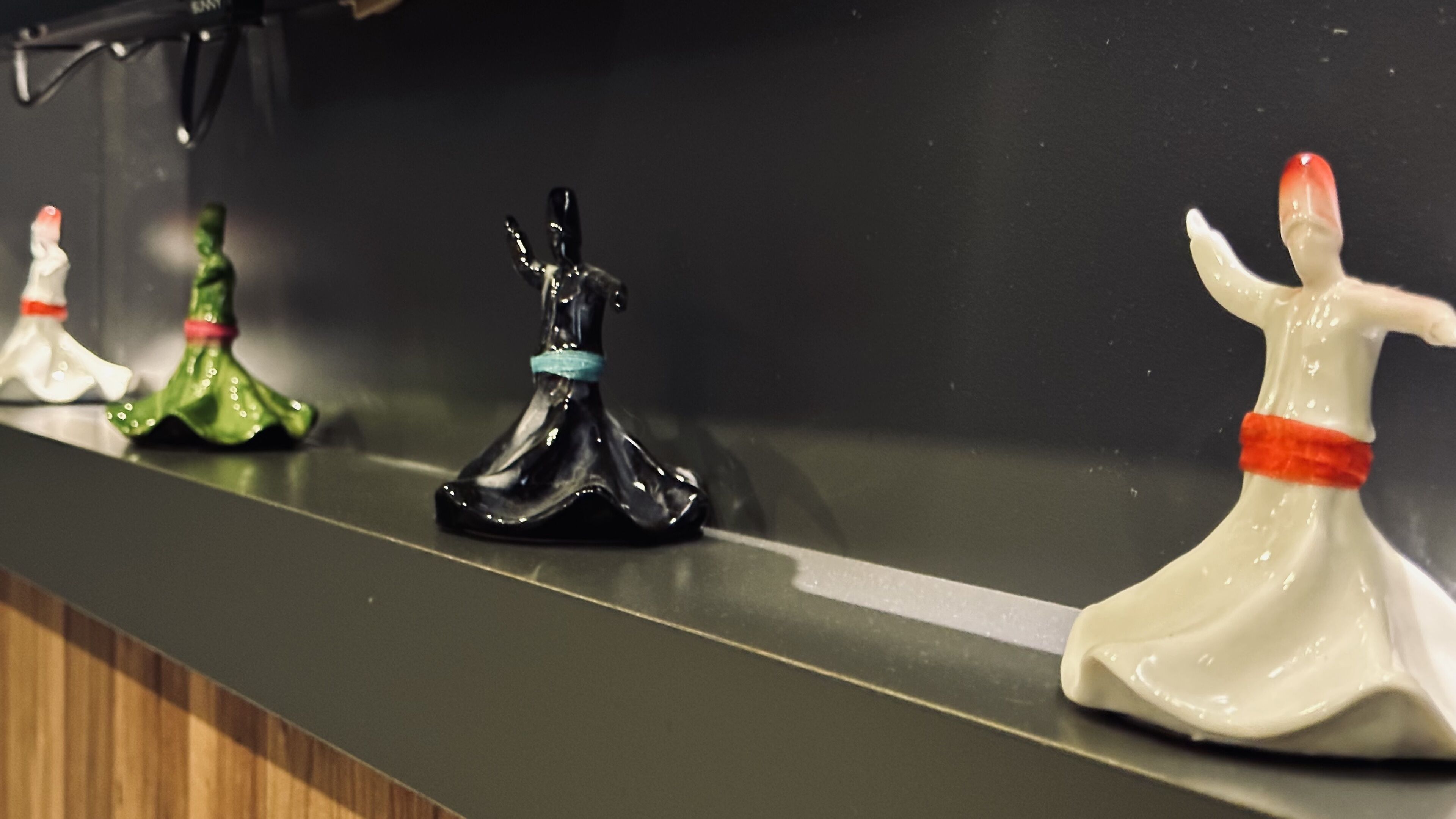 A row of decorative figurines on a dark countertop.