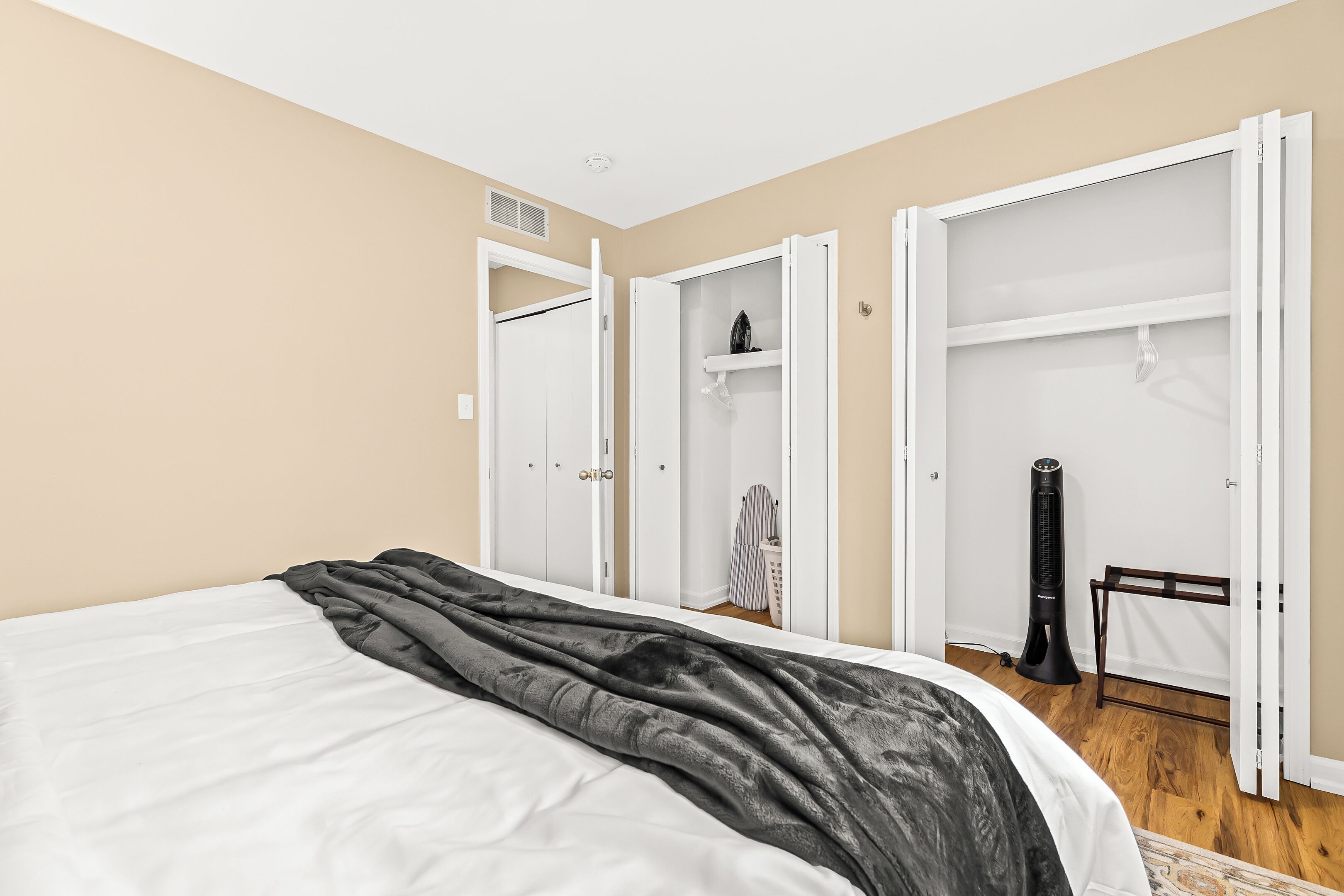 A bedroom with a bed, a wardrobe, and a heater.