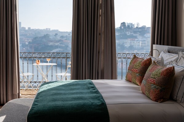 Relax in a spacious room with a large bed, city views, and a balcony.