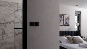 A modern bedroom with a marble wall, a bed with dark headboard, and a large window. - Soho in Starigrad With 6 Bedrooms and 6 Bathrooms (Starigrad)