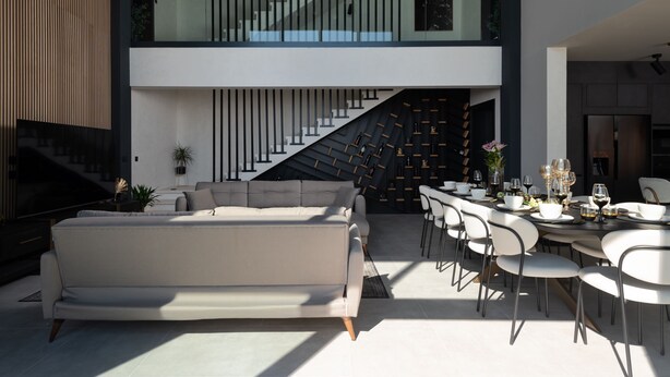 A modern interior with a sofa, dining table, chairs, and a staircase. - Soho in Starigrad With 6 Bedrooms and 6 Bathrooms (Starigrad)