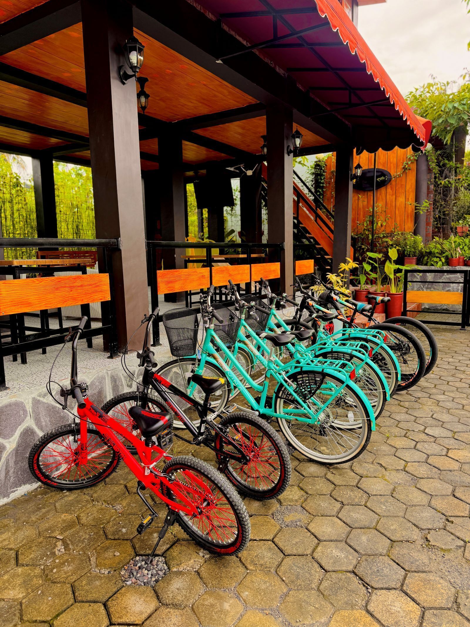 A covered outdoor seating area with multiple bicycles parked in front.