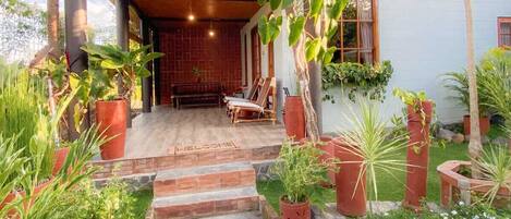 A modern house with a stone pathway leading to a wooden porch.