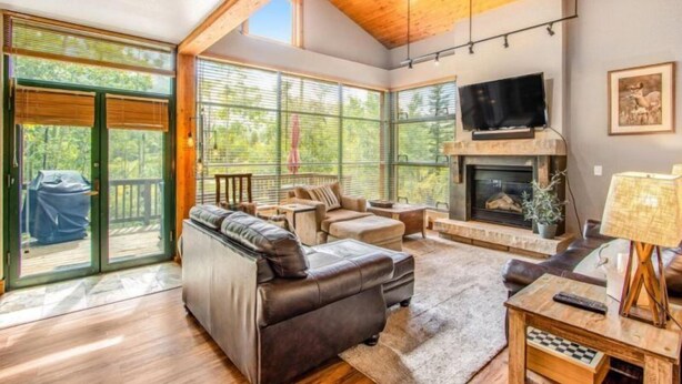 A spacious living room with a fireplace, leather sofa, and a television. - Lovely Townhome a Half-mile From Keystone Gondola W/shared Hot-tub & Excellent Views (Keystone)