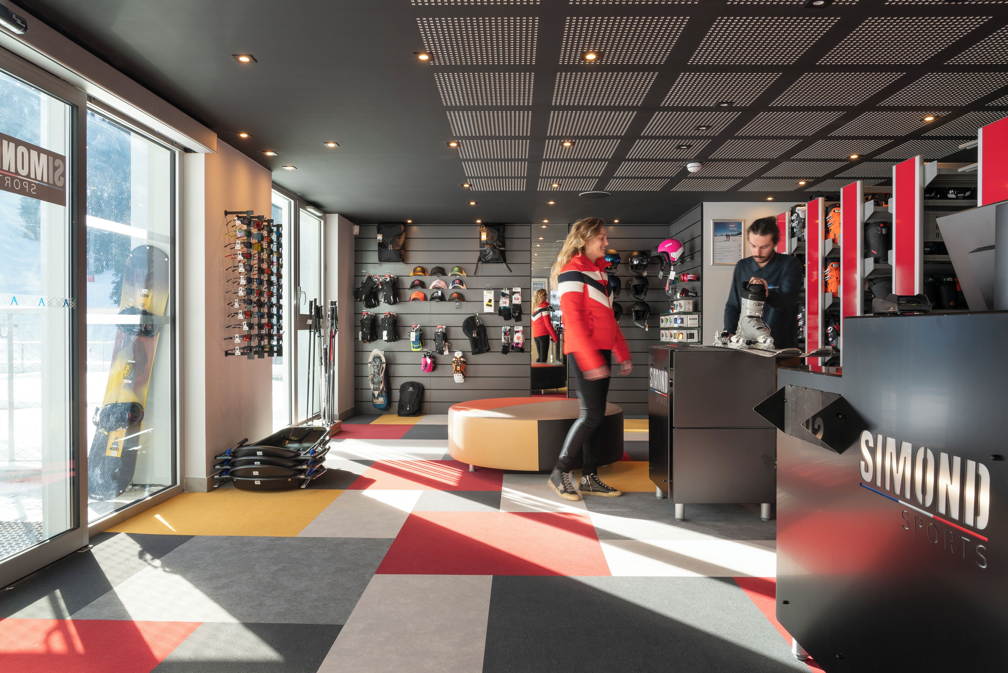A sports equipment store with a variety of helmets and gear on display.