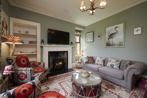 TV connectée, cheminée, table de tennis de table, livres