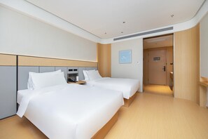 A hotel room with two beds, a bedside table, a wall-mounted TV, and a door leading to another room. - Ji Hotel Hefei Mingzhu Square (Hefei)