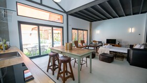 A modern kitchen with a dining area, a sofa, and a TV. - Elegant and luxurious apartment in Madrid Tempory (Madrid)