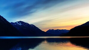 A calm lake with mountains in the background and a clear sky. - dfdfdfdfdfd (Amritsar)