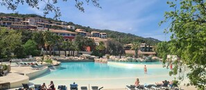 A resort with multiple swimming pools, lounge areas, and a hillside backdrop. - Rare pearl with pool and beautiful sea view (Grimaud)