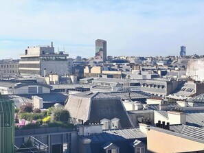 A cityscape with various buildings, including a prominent tower and multiple rooftops.