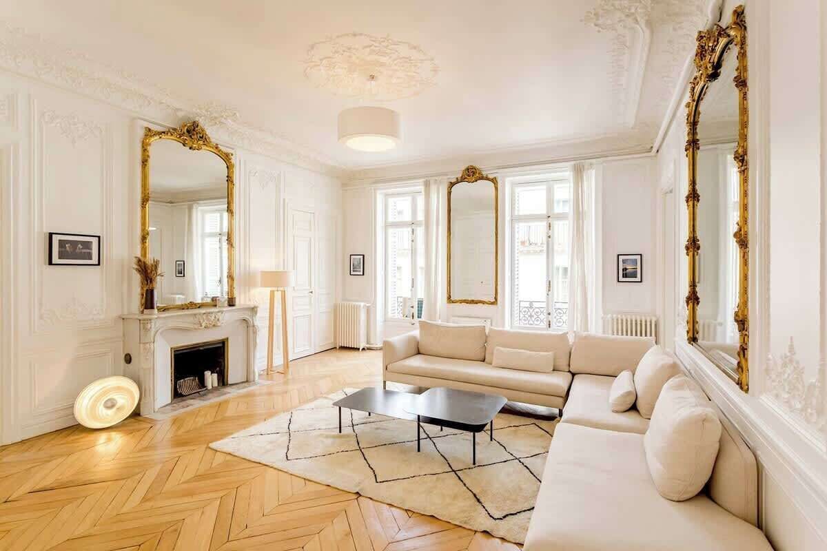 A spacious living room with a fireplace, a sofa, and a coffee table.