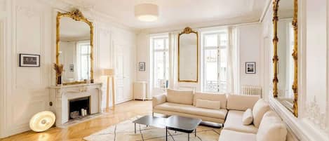 A spacious living room with a fireplace, a sofa, and a coffee table.