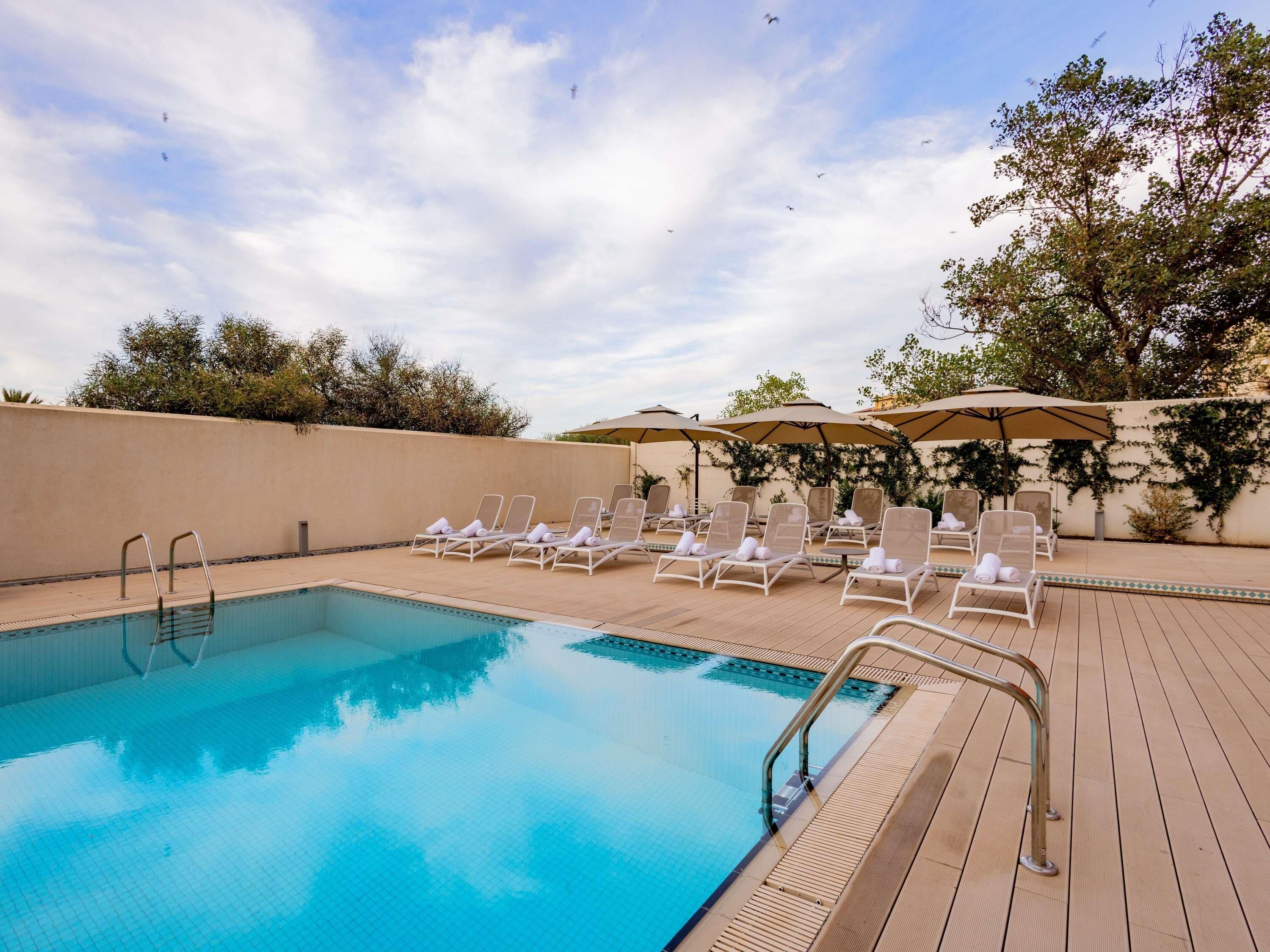 Outdoor pool, open 10:00 AM to 7:00 PM, pool umbrellas, sun loungers