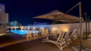 Outdoor pool, open 10:00 AM to 7:00 PM, pool umbrellas, pool loungers