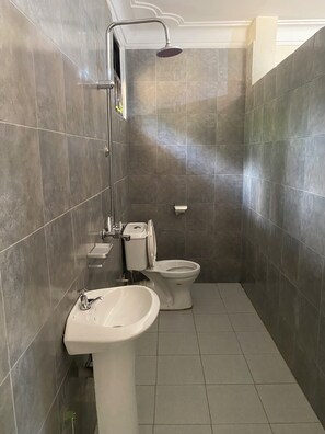 A bathroom with a shower, toilet, and sink. - The Fortuna Hotel and Cafe (Kabale)