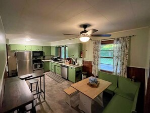 Enjoy meals in the kitchen with a dining table and a window offering a view of the outdoors.