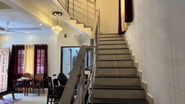 Eine Treppe mit Handlauf, die zu einer oberen Etage führt.