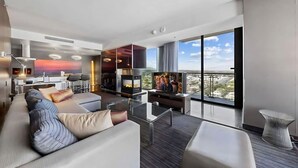 Ein modernes Wohnzimmer mit einer Couch, einem Fernseher und einem Kamin.