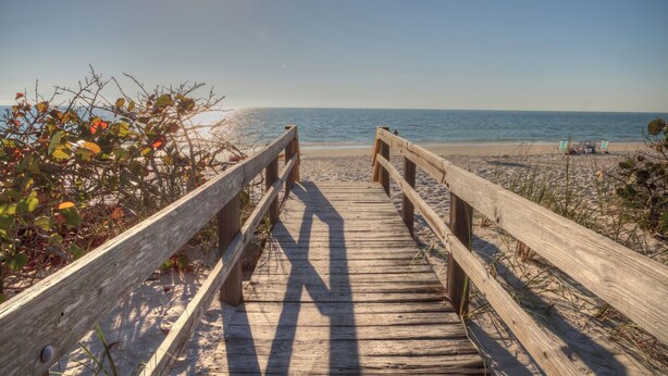 A wooden boardwalk leading to a beach with clear skies. - Blue Water Retreat @ Vanderbilt- steps to beaches/shopping/dining/entertainment! (Naples)