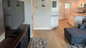 A modern apartment with a living room, kitchen, and dining area. - Blue Water Retreat @ Vanderbilt- steps to beaches/shopping/dining/entertainment! (Naples)