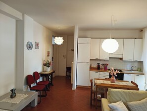 Cozy living space with a fully equipped kitchen, dining area, and comfortable seating.
