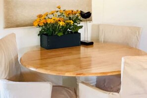 Enjoy meals around a round dining table with four comfortable chairs.