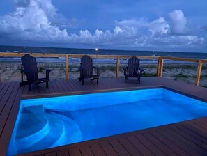 Relax on the deck overlooking the ocean with a tranquil view.